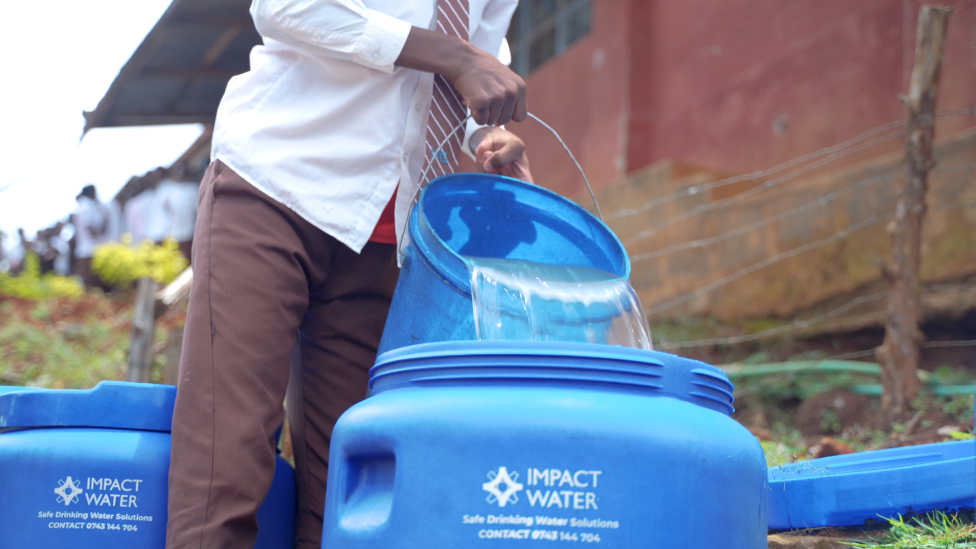 Community-led initiatives, like this water distribution point, play a vital role in providing safe water and preventing cholera.