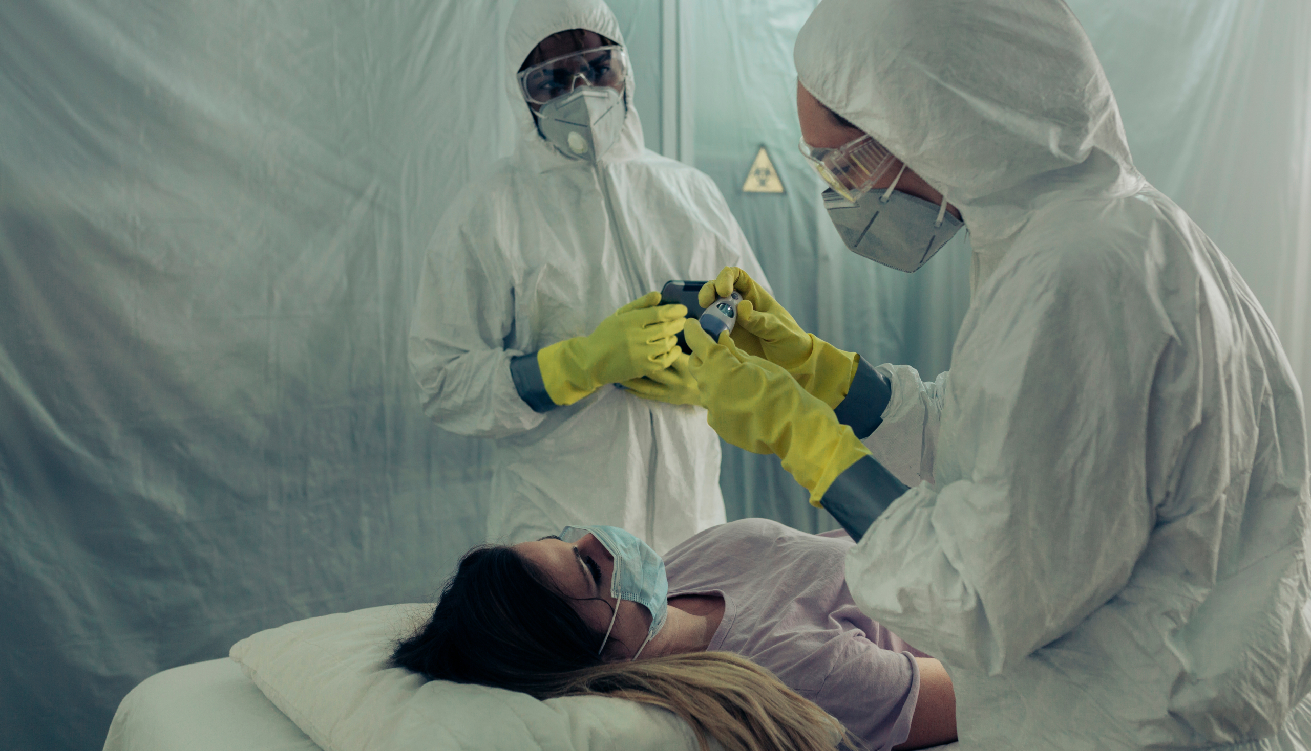 Patient on a stretcher receiving care in a field hospital, a scenario relevant to protecting healthcare workers Ebola Uganda during outbreaks in remote areas.