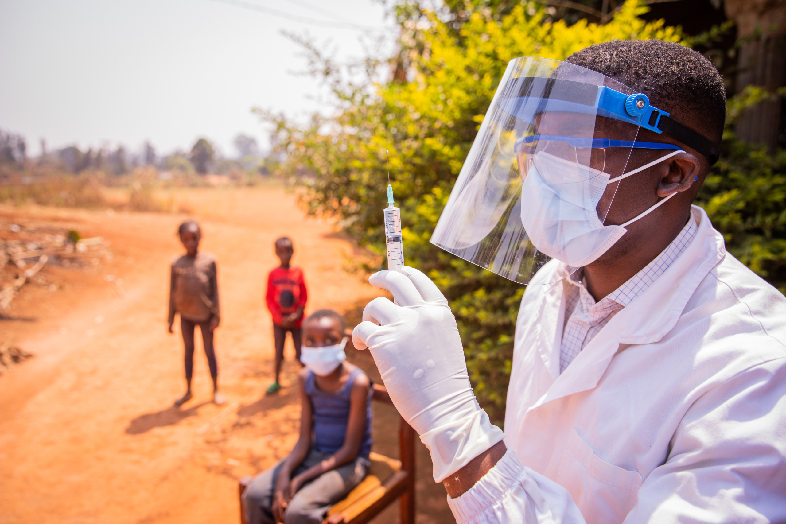 African doctor vaccinating children. Preventative measures like this are crucial in healthcare, a concept that applies to protecting healthcare workers Ebola Uganda from outbreaks