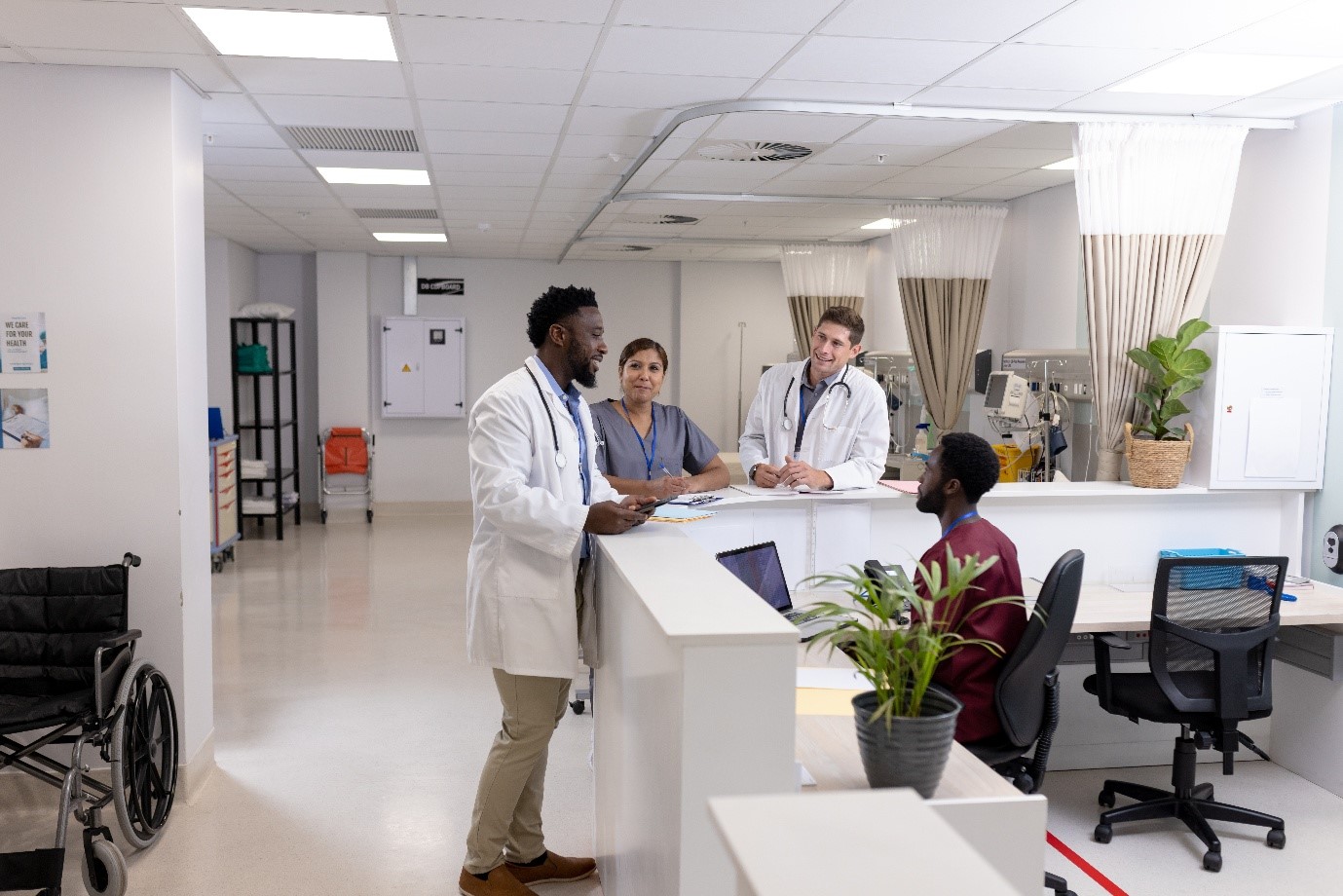 Teamwork and communication among medical staff at a hospital ward reception desk.