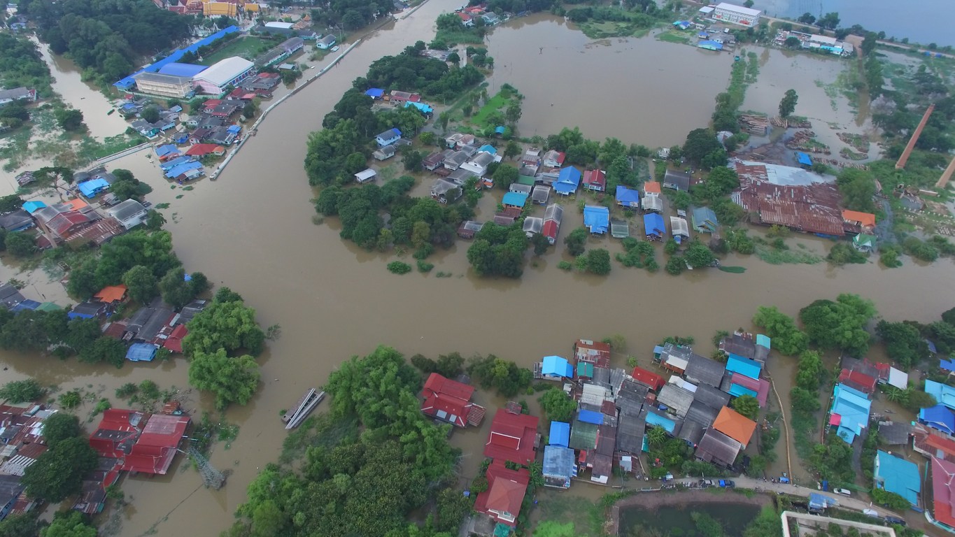 Aerial view of Peru floods: Houses submerged in muddy water, highlighting the need for safe water access.